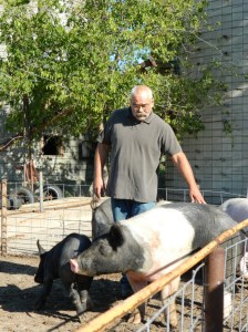 Amos Hinton with his project's pigs. Photo courtesy of the First Nations Development Institute