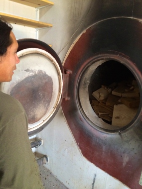Angelo McHorse showing us the GARN biomass furnace. Photo by Elizabeth Hoover