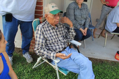 Muscogee elder Sam Proctor, holding corn seed and reminiscing about the types of corn that his mom used to grow and cook