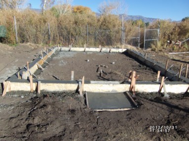 Pouring the foundation for the greenhouse. Photo by Keith Glidewell