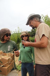 Jake, Melissa and John testing a peach with a refractometer to determine the brix, which is the percentage of dissolved solids in fruit, usually sugar. This peach fresh off a near by tree tested at 16 ½ brix which is great (according to John 12 or 13 would have been ok). Photo by Angelo Baca