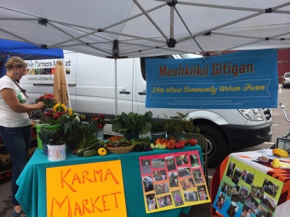 Annelie Lindgerg-Livingston, the administrative coordinator for the Mashkiikii Gitigan garden, at the Karma Market set up as past of the Open Streets festival on Franklin Ave. Photo by Elizabeth Hoover