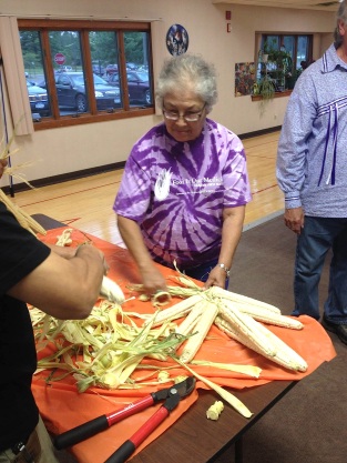 Braiding corn at one of the Elders Sharing Circle events. Photo courtesy of Food Is Our Medicine