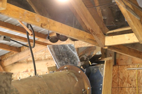 The rice is drawn up a chute, moved laterally by this rotor, and dropped