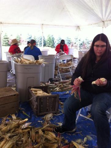 Husking corn. Photo by Elizabeth Hoover (October 2013)