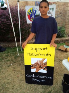 Elijah (Winnebago) at the DOWH farmers market stand. Photo by Elizabeth Hoover