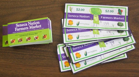 Coupons given to kids to buy fruits and vegetables at the farmers market. Photo by Elizabeth Hoover
