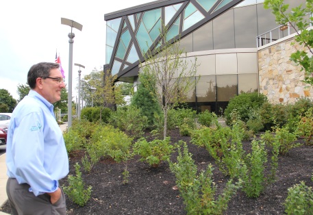 Ken Parker explaining the varieties of native plants that comprise the landscaping in front of the William Seneca building. Photo by Elizabeth Hoover