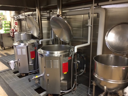 The smaller kettle to the right is run by steam, powered by the boiler (which was not working in August). Luckily the cannery also owns gas powered kettles in which they have continued to process the white corn. Photo by Elizabeth Hoover (August 2014)
