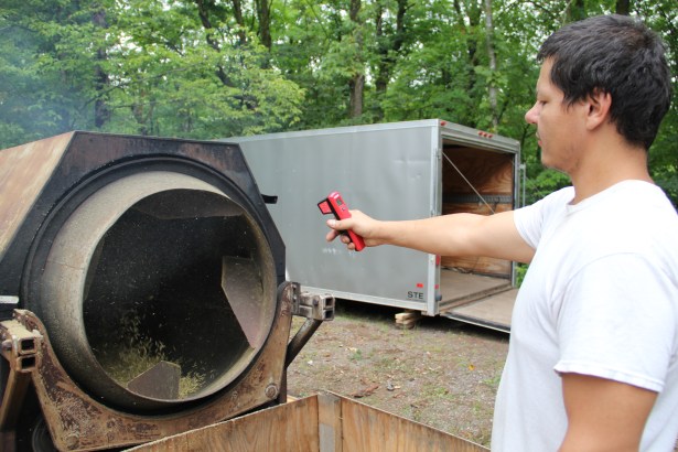 Taking the temperature of the roasters. That chaff you see coming out the front clings to everything at the site-- I left completely covered. It's an itchy job! Photo by Elizabeth Hoover 8/30/14