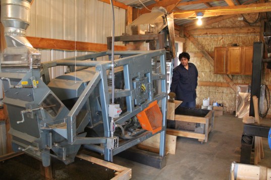 The de-hulled rice is then sent to another machine to have the remaining chaff removed. Photo by Elizabeth Hoover