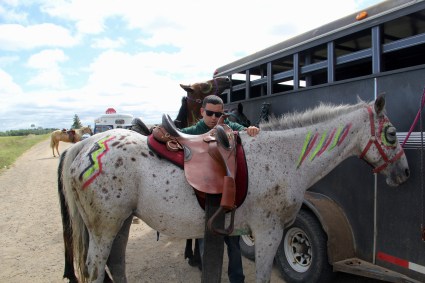 Charlie Thayer (Ojibway) saddling his horse. Photo by Elizabeth Hoover