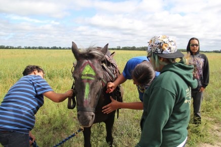 Ashley, Gwe and Gloria painting up the horses for the ride. Photo by Elizabeth Hoover