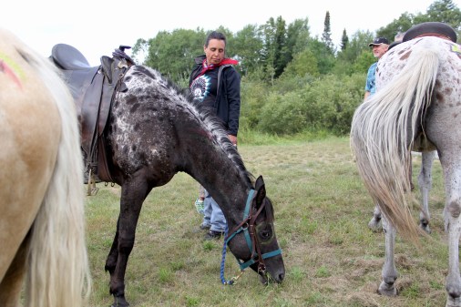 Winona LaDuke grazing her horse during one of the breaks along the ride. Photo by Elizabeth Hoover