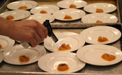 Sean flambeing maple sugar on top of the squash. Photo by Elizabeth Hoover