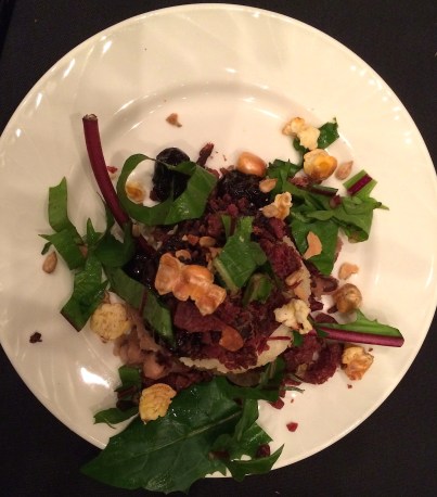 Sean's corn cake with dandelion greens, wojapi, dried buffalo meat, and a cracked corn/sunflower seed pepita mix. Photo by Elizabeth Hoover